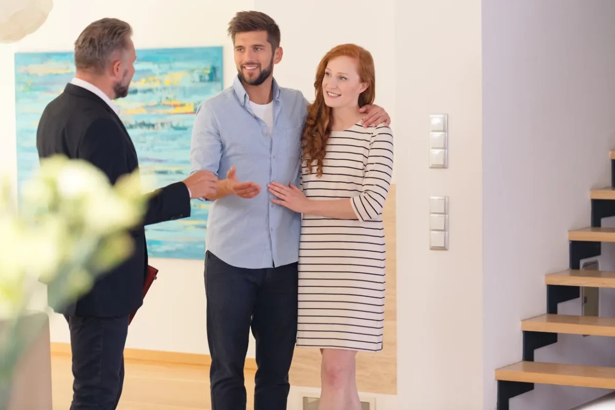 Couple with realtor looking at vacation rental property