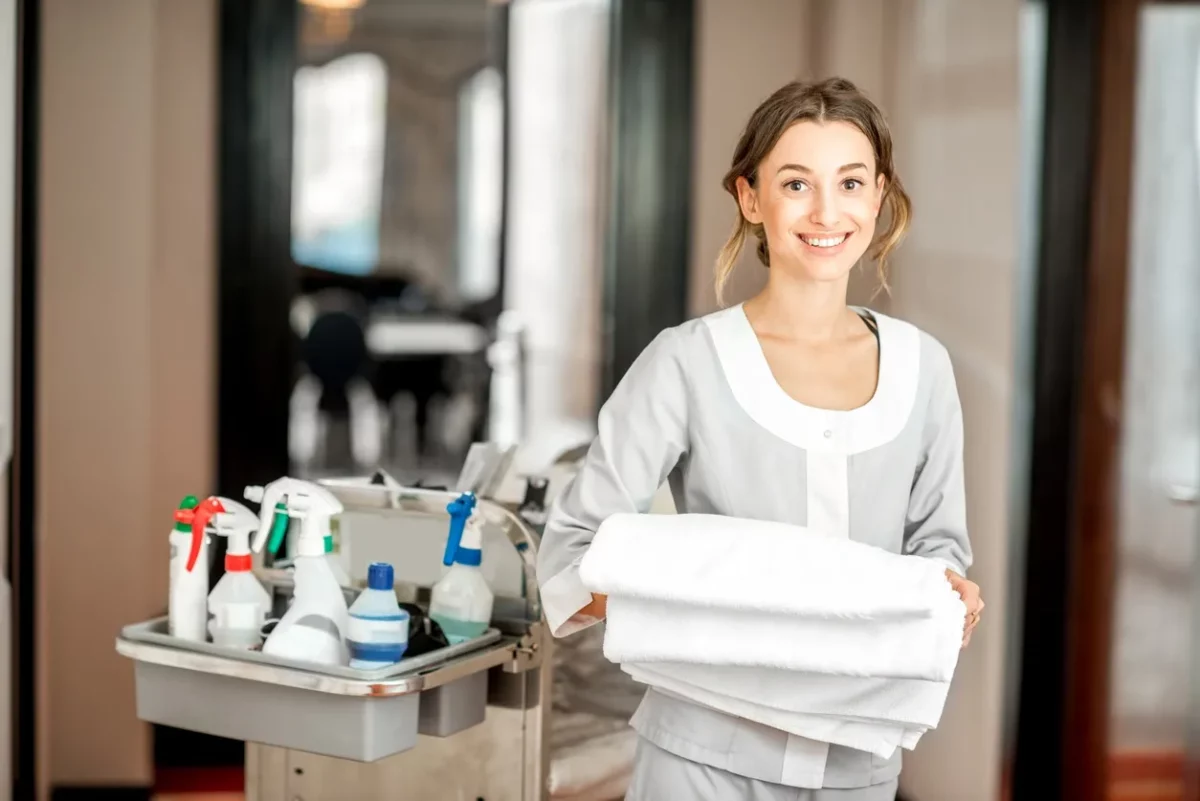 hydeaway stay housekeeper holding towels in a vacation rental property