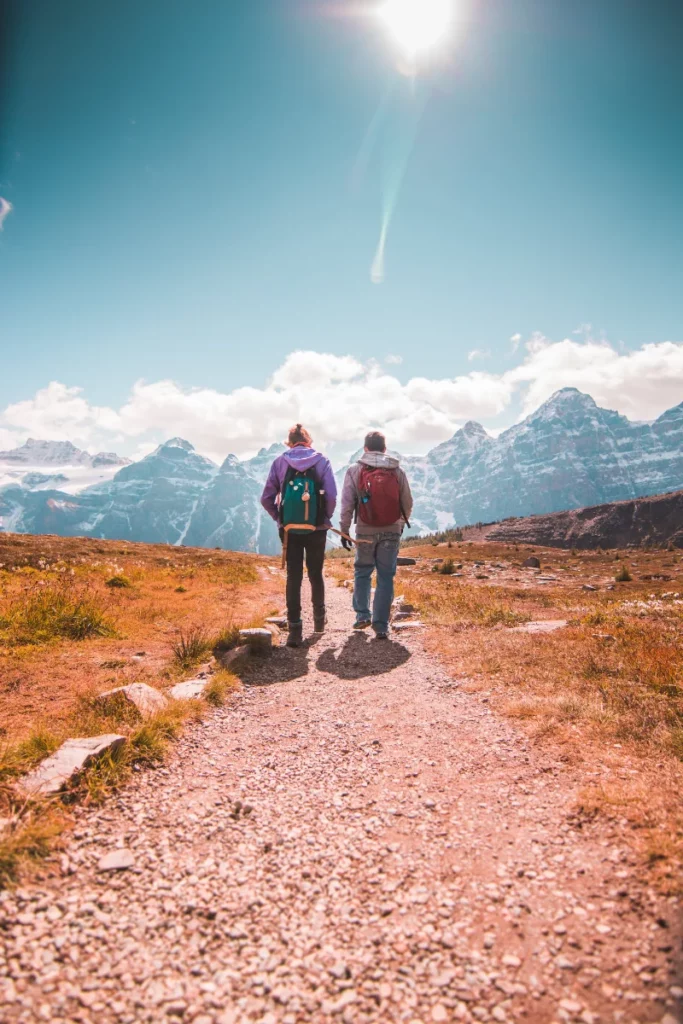 couple walking in mountains near their vacation rental in the canadian rockies